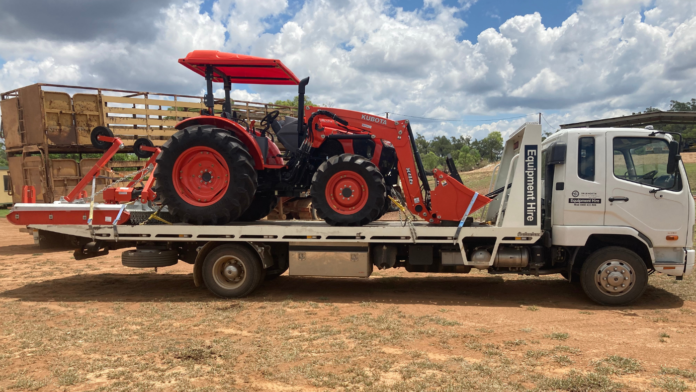 7 tonne tilt truck carrying a tractor